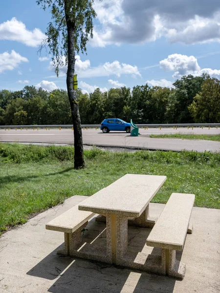 picnic table and benches on resting area near parking of french motorway