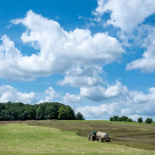 stock image French farmer in tractor spreads manure on field in the area of Champagne Ardennes in France