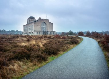 Building A of radio kootwijk ion veluwe landscape in the netherlands near apeldoorn under grey sky clipart