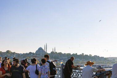 Arka planda turistler ve yerel halk Galata Köprüsü ve Süleyman Camii. İstanbul 'daki arka plan fotoğrafına git. İstanbul Türkiye - 8.20.2022