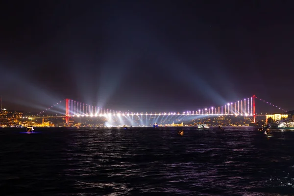 Bosphorus Bridge and spotlights. Travel to Istanbul background photo. 15th july martyrs\' bridge at night. Noise included.
