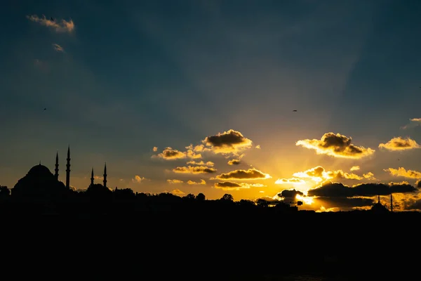 Silhouette of Istanbul at sunset and crepuscular rays. Islamic concept photo. Istanbul view.