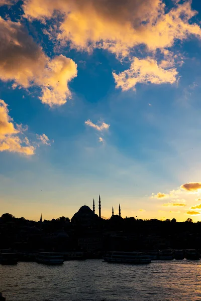 Islamic photo. Silhouette of Suleymaniye Mosque at sunset with partly cloudy sky. Ramadan or islamic vertical background photo.