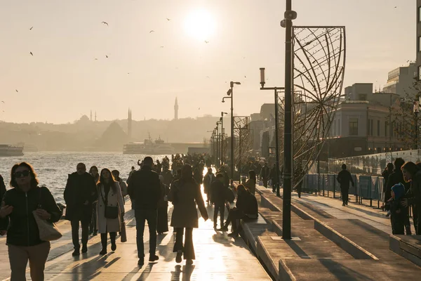 Galataport and cityscape of Istanbul with people or tourists at sunset. Istanbul Turkiye - 12.24.2022