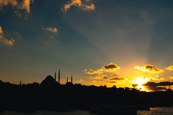 Istanbul silhouette. Sunlight rays and Suleymaniye Mosque at sunset. Travel to Istanbul background photo. Ramadan or islamic concept photo.