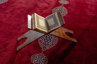 Islamic or ramadan concept photo. Holy Quran on the lectern in top view. Kandil or laylat al-qadr concept. Istanbul Turkiye - 1.18.2023