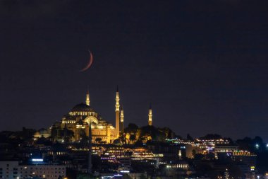 Ramadan concept photo. Crescent moon and Mosque. Islamic or kandil or laylat al-qadr background. Noise included.