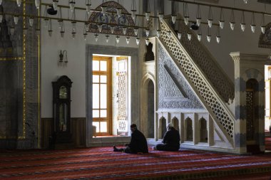 Islamic or ramadan concept photo. Muslim elder men praying in the mosque. Konya Sultan Selim Mosque. Konya Turkiye - 5.18.2022