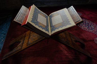 Ramadan or islamic background photo. The Holy Quran or Kuran-i Kerim on the lectern or rahle in Turkish. Istanbul Turkiye - 1.18.2023