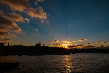 Silhoeutte of Istanbul at sunset with dramatic clouds and sunrays. Ramadan or islamic concept photo.
