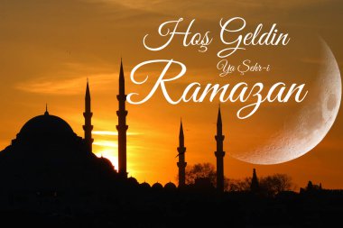 Günbatımında Süleyman Camii 'nin silueti ve hilal ay. Hos Geldin ya Sehr-i Ramazan. Kutsal Ramazan ayına hoş geldiniz..