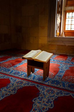 Ramazan veya İslami dikey arkaplan fotoğrafı. Kutsal Kur 'an bir camide kitap standında..