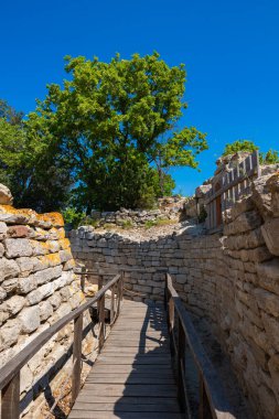 Ruins of Troy and wooden walkway. Visit Turkey concept photo. Troy ancient city in Canakkale Turkiye. clipart