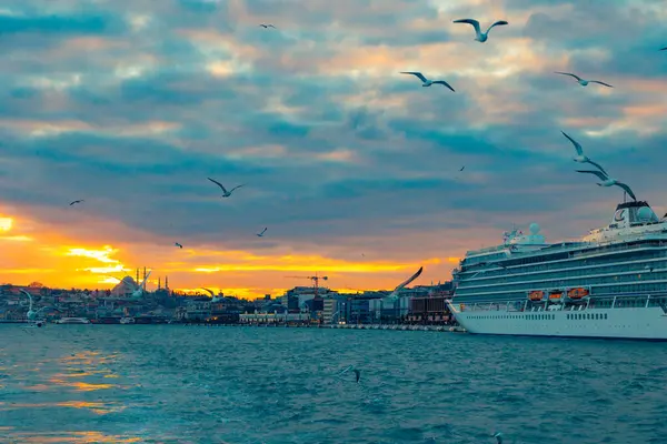 stock image Cruise ship docked at Galataport and cityscape of Istanbul at sunset. Istanbul Turkiye - 1.22.2024