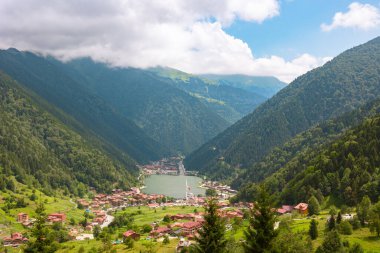 Trabzon Uzungol. A view of Uzungol town in Trabzon with clouds and forest in the summer. clipart