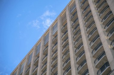 Açık mavi gökyüzüne karşı balkonları olan apartman dairelerinin dış görünüşü. Güneşli bir günde, Austin Texas 'ın gökyüzüne yerleşim binaları ya da daireleriyle bakıyorum..