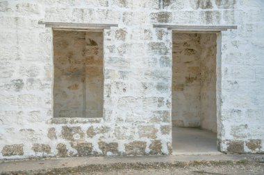 San Antonio, Texas- Abandoned doorless and windowless building exterior. Facade of an old building with weathered white stone blocks wall. clipart