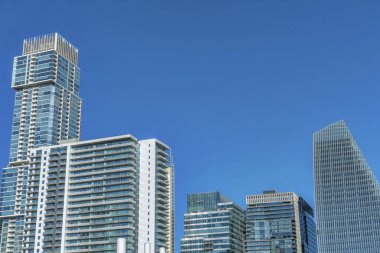 Austin, Teksas. Modern apartman ve gökyüzüne karşı farklı yapıları olan apartmanlar. Kenar mimari yapıları ve cam dış görünüşlü gökdelenleri olan şehir manzarası.