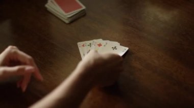 Playing cards at the table, hands with playing cards, close-up. High quality 4k footage