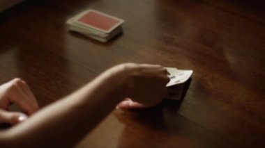 Playing cards at the table, hands with playing cards, close-up. High quality 4k footage