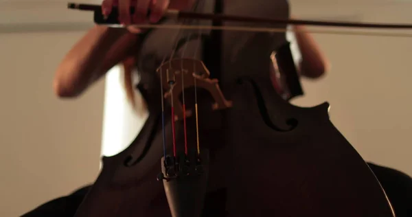 stock image Single woman playing the cello, close-up and medium close-up, cello bow and strings, smooth transitions of the camera from focus to out-of-focus, beautiful filmic, artistic shots.