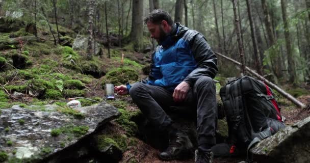 Bir Gezgin Yağmurlu Havada Ormanda Bir Gaz Ocağında Çay Hazırlar — Stok video