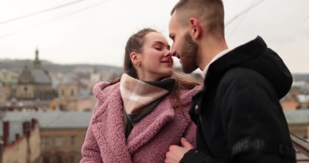 愛する若いカップルのキスと抱擁 暗い秋の日に市内中心部の若いカップルのロマンチックなミーティング ハッピーボーイとガールハグ 一緒に時間を楽しむ — ストック動画