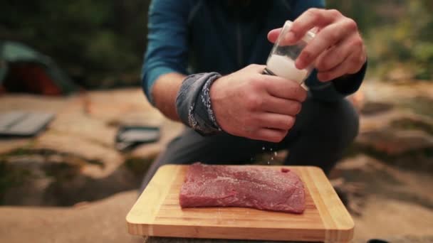 Ein Einzelner Tourist Kocht Rindersteak Streut Salz Auf Den Hintergrund — Stockvideo