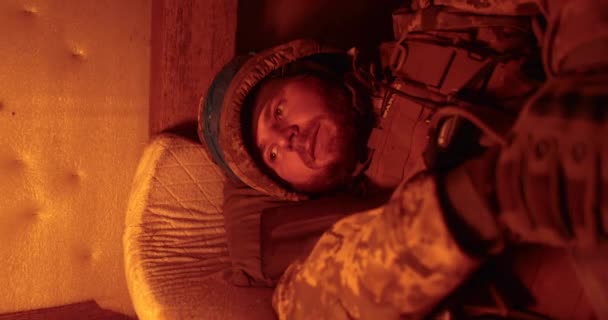 一个士兵躺在燃烧着的战壕蜡烛的闪光中 躺在排污口里 乌克兰士兵在毒气室 — 图库视频影像
