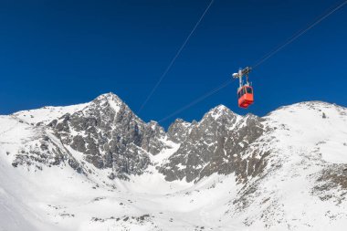 Snowy winter high mountain landscape. Cable car to The Lomnicky peak in High Tatras National Park, Slovakia, Europe.