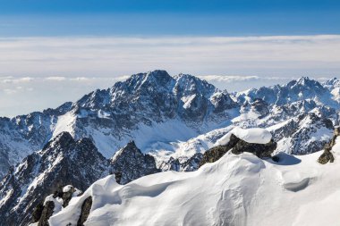 Snowy winter high mountain landscape. A panoramic view from the top of The Lomnicky peak in High Tatras National Park, Slovakia, Europe.
