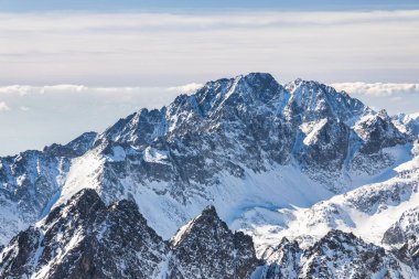Snowy winter high mountain landscape. A panoramic view from the top of The Lomnicky peak in High Tatras National Park, Slovakia, Europe.