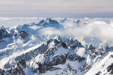 Snowy winter high mountain landscape. A panoramic view from the top of The Lomnicky peak in High Tatras National Park, Slovakia, Europe.