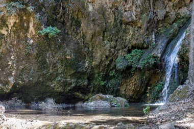 Waterfall in The Valley of Butterflies. The Petaloudes valley nature reserve in Rhodes, Greece, Europe.