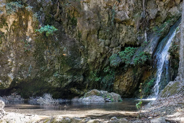 Waterfall in The Valley of Butterflies. The Petaloudes valley nature reserve in Rhodes, Greece, Europe.