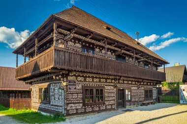 CICMANY, SLOVAKIA - 25 Mayıs 2019: Zilina Bölgesindeki Cicmany köyünün halk mimarisi. Ahşap evlerin ön cephelerinde karakteristik desenler.