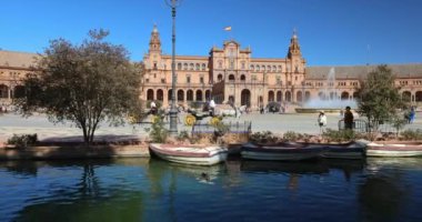 Seville, İspanya - 8 Eylül 2024: İspanya 'nın başkenti Endülüs' teki Plaza de Espana Meydanı. At arabaları, merkezi bir çeşme ve kanalda tekneleri olan pitoresk bir plaza..