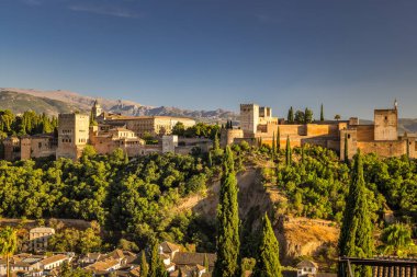 Gün batımında İspanya 'nın Granada kasabasındaki Mirador de San Nicolas manzaralı Alhambra Panoraması. Kasabaya tepeden bakan antik bir şato, altın güneş ışığıyla yıkanmış..