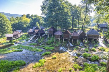 Bosna-Hersek 'in Jajce kasabası yakınlarındaki Pliva Nehri' ndeki Mlincici ahşap su değirmenleri. Resimli eski ahşap su değirmenleri küçük şelaleler üzerinde eşsiz bir manzara oluşturur..