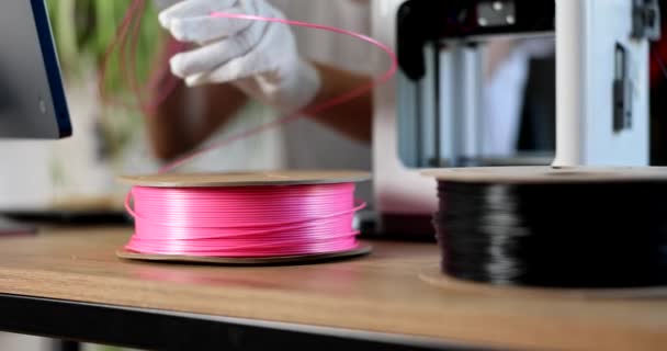 戴手套的工程师为3D打印机持有粉色塑料 3D打印材料的选择 — 图库视频影像
