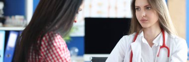 Portrait of female patient at doctor appointment, incurable disease. Doctor calming down upset woman. Healthcare and medicine concept