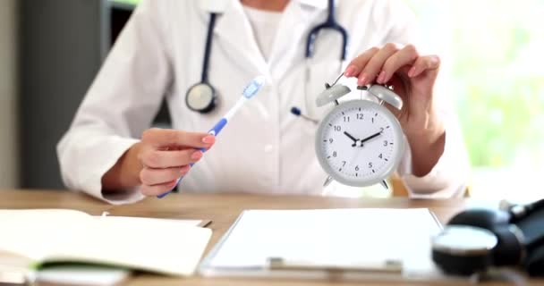 Doctor Dentist Holds Toothbrush Alarm Clock Time Proper Dental Hygiene — Stock Video