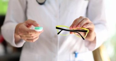 Doktor elleri gözlük ve kontakt lens seçimini elinde tutuyor. Hyperopia miyop astigmat konsepti