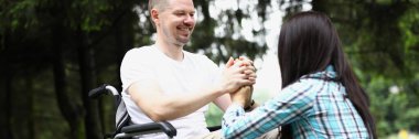 Portrait of wife and husband have meeting in nursing home, support in recovery. Disabled people problem, healthcare, family, support, help, nature concept