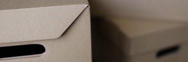 Close-up of empty solid cardboard boxes with covers, beige containers to storage things. Full packages of stuff sorted separately. Storage, keeping concept