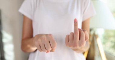 Woman twisting her hand and showing gesture fuck you closeup 4k movie slow motion. Negative mood and behavior concept