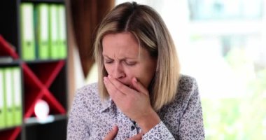 Portrait of unhealthy beautiful heavily coughing woman. Girl suffering from cough with chest pain