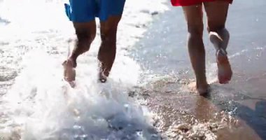 Happy young couple running on sea beach. Emotions happiness love joy honeymoon on vacation