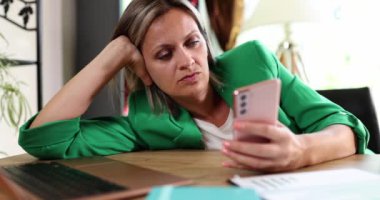 Businesswoman sad depressed holding smartphone and waiting for call and sms. Negative emotions anxiety and reading news online