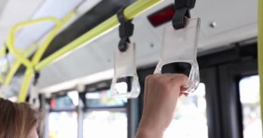 People hold hand on train or bus. Safety in public transport